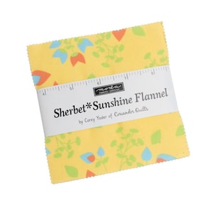 May include: A stack of yellow Sherbet Sunshine Flannel fabric squares with a floral pattern in orange, blue, and green. The fabric is wrapped with a white band that reads "Sherbet*Sunshine Flannel" and "by Corey Yoder of Coriander Quilts."