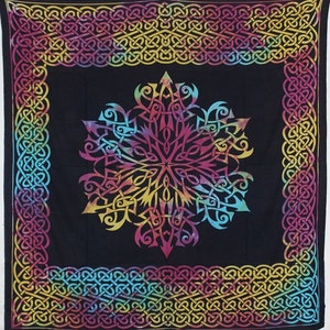 May include: A black tapestry with a colorful Celtic knot design. The design features a large, intricate knot in the center surrounded by a border of smaller knots.