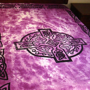 May include: Purple tie-dye tapestry with a black Celtic cross design. The cross is surrounded by a circle of intricate knotwork.