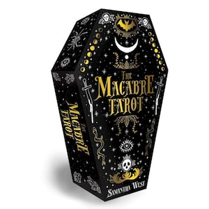 May include: A black coffin-shaped box with gold lettering that reads "The Macabre Tarot" by Samantha West. The box is decorated with stars, moons, snakes, and other macabre imagery.