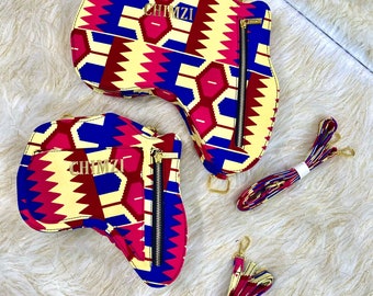 May include: Three colorful patterned handbags with gold chains and matching straps. The bags are shaped like an Africa continent and have the word "CHIMZI" printed on them.