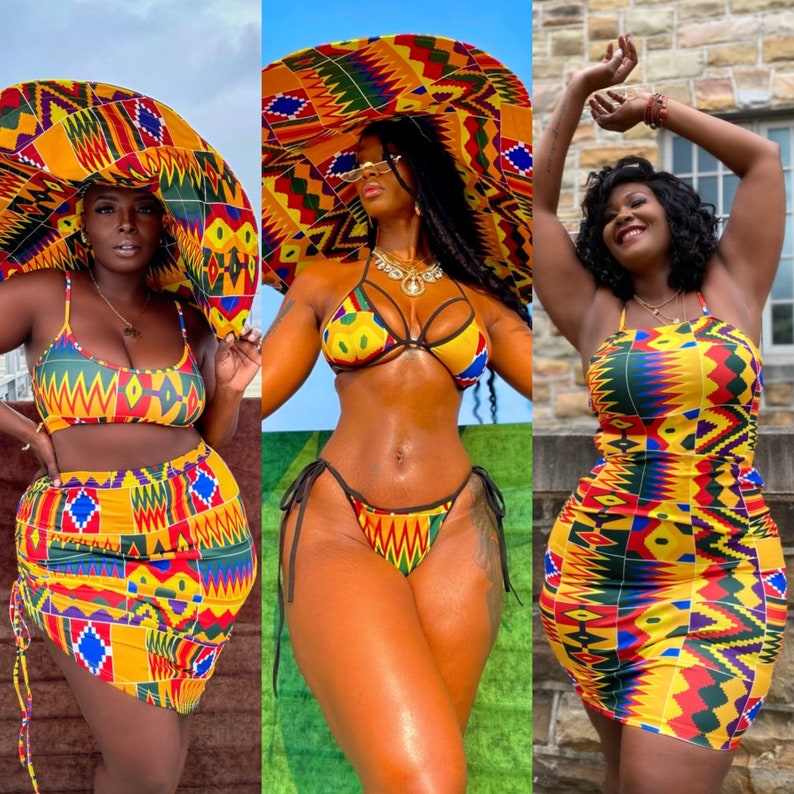 Op de afbeelding: Drie vrouwen dragen kleurrijke, gepatroneerde badpakken en rokken. De badpakken zijn een bikini-top en -onderdeel met een kruisontwerp. De rokken zijn in wikkel-stijl met een hoge taille. De patronen zijn geel, rood, groen en zwart.