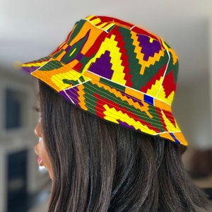 Op de afbeelding: Een gele, rode, groene en paarse bucket hat met een geometrisch patroon.