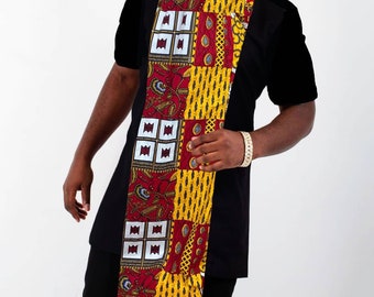 May include: A black short-sleeved shirt with a long, colorful patterned fabric sash. The sash is made of red, yellow, and white fabric with geometric and floral designs.