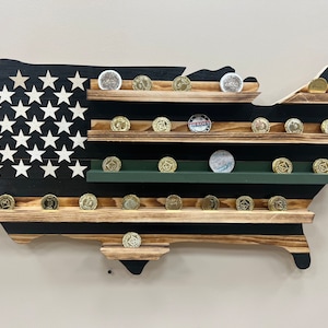 May include: Wooden US map coin display with black and white stripes representing the American flag. The map has multiple shelves for displaying coins. The shelves are made of wood with a natural finish.