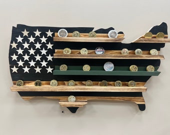May include: Wooden US map coin display with black and white stripes representing the American flag. The map has multiple shelves for displaying coins. The shelves are made of wood with a natural finish.