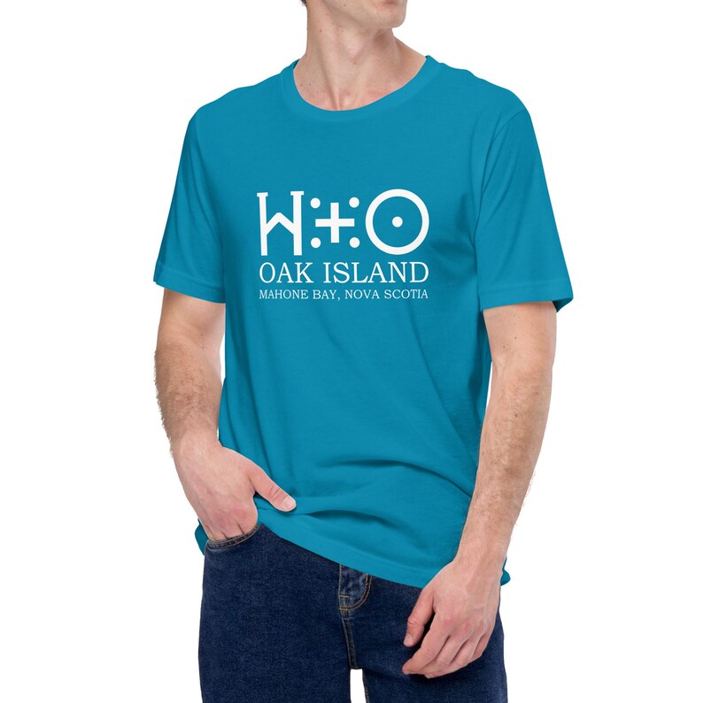 May include: A turquoise blue t-shirt with a white graphic of the Oak Island symbol, "W:O", and the text "Oak Island, Mahone Bay, Nova Scotia".