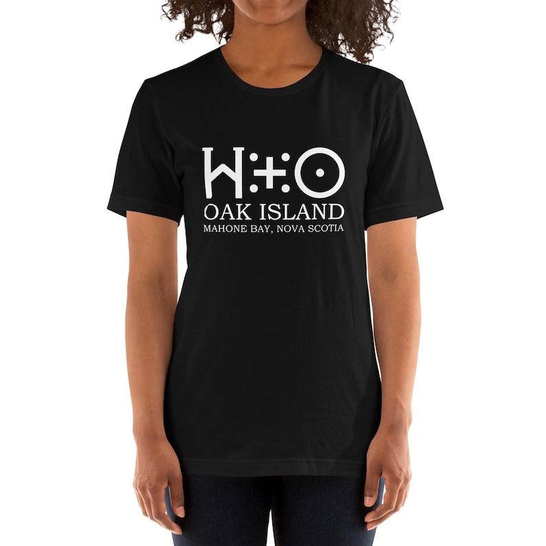 May include: Black t-shirt with a white graphic of the Oak Island symbol, "W:O", and the text "Oak Island, Mahone Bay, Nova Scotia."