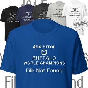 May include: A blue t-shirt with white text that reads "404 Error Buffalo World Champions File Not Found". The text is in a pixelated font, and there is a pixelated sad face icon above the word "Buffalo".