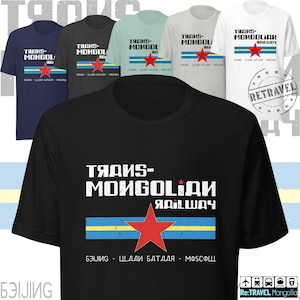 May include: A collection of t-shirts in various colors, each featuring a design with the text "TRANS-MONGOLIAN RAILWAY" in white, a red star, and a blue and yellow stripe. The text "BEIJING - ULAANBAATAR - MOSCOW" is also present.