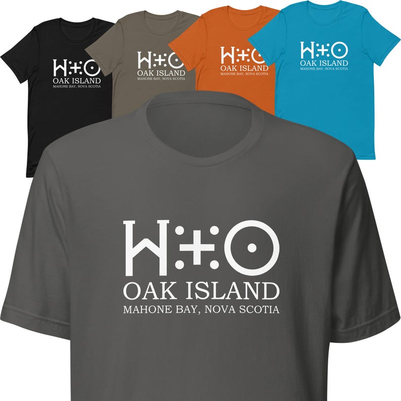 May include: A gray t-shirt with a white graphic of the Oak Island symbol and the text "HO OAK ISLAND MAHONE BAY, NOVA SCOTIA".