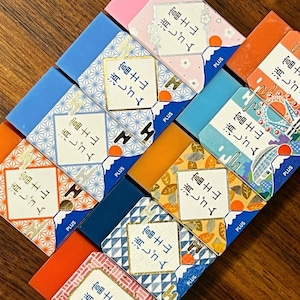May include: A collection of colorful erasers with Japanese text that reads "Mount Fuji Eraser". The erasers feature different designs, including a mountain range, a cityscape, and a floral pattern.