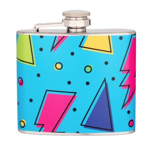 May include: A stainless steel hip flask with a blue, pink, yellow, and green geometric pattern.