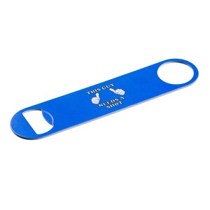 May include: A blue bottle opener with the text "THIS GUY NEEDS A SHOT" in white. The opener has a circular hole at one end and a bottle cap opener at the other.