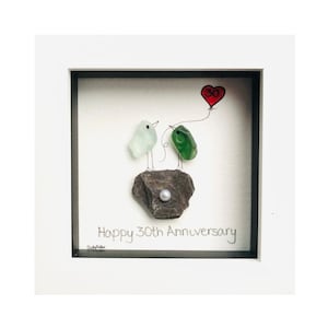 May include: A framed artwork featuring two glass birds perched on a rock, with a red heart-shaped balloon that has the number 30 on it. The text "Happy 30th Anniversary" is written below the birds.