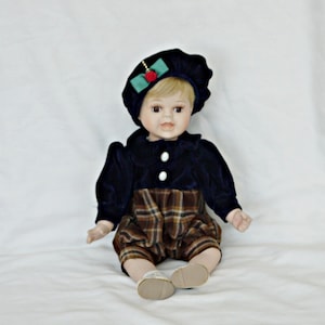 large porcelain doll boy vintage collectors doll boy siting art doll boy with  hat smiling boy happy boy