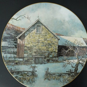 May include: A vintage style painting of a stone farmhouse with a snow-covered roof in a winter landscape. The farmhouse has a single window and a wooden door. The scene is framed by a rustic wooden fence and a snow-covered field.