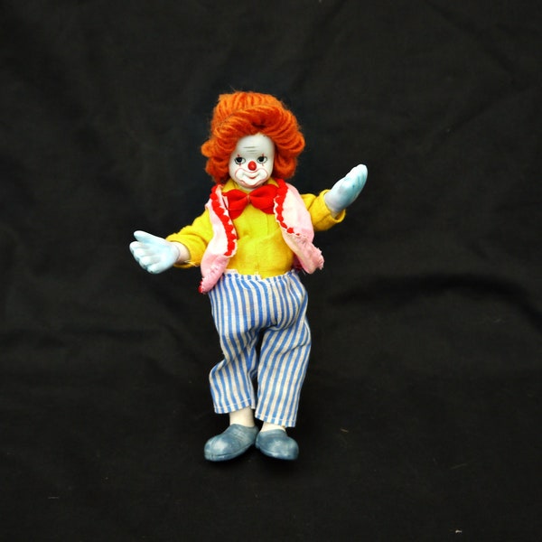 vintage collectors clown porcelain and stuffed moving art figurine doll clown marionette dressed pink red blue jumpsuit Red hair display