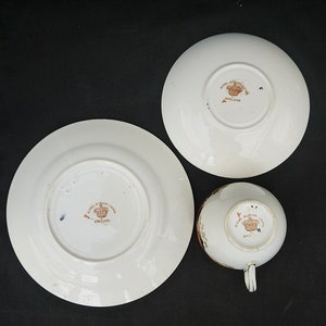 May include: Three white porcelain teacups and saucers with a floral design. The bottom of each piece has a brown stamp that reads "Royal Albert China England".
