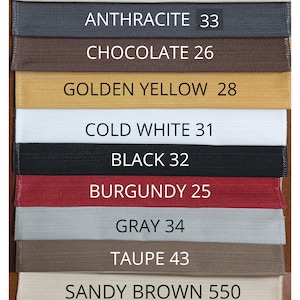 May include: A color swatch chart featuring twelve horizontal fabric strips in various colors, each labeled with a name and number: White Pearly 01, Light Beige 02, Anthracite 33, Chocolate 26, Golden Yellow 28, Cold White 31, Black 32, Burgundy 25, Gray 34, Taupe 43, Sandy Brown 550, Christmas Red 220, and Blue 221.
