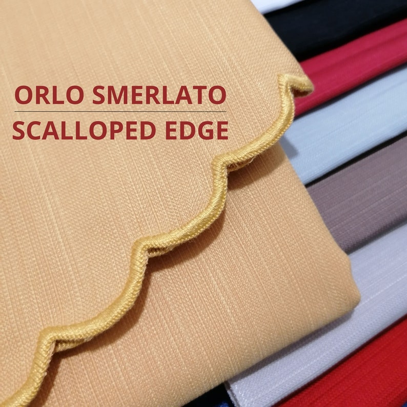 May include: A stack of textured fabric swatches in various colors including beige, black, red, light blue, and grey. The top beige fabric features a scalloped edge with stitched detailing and the text ORLO SMERLATO SCALLOPED EDGE printed in red.