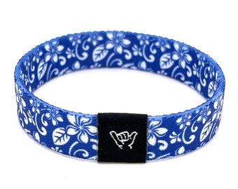 May include: Blue and white patterned wristband with a black buckle featuring a white hand gesture.