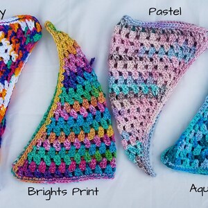 May include: Four crocheted triangle scarves in different color patterns: "Sunshine", "Brights Print", "Pastel", and "Aqua Ombre".