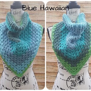 May include: Blue, green, and gray crocheted cowl with a textured stitch pattern. The cowl is displayed on a mannequin.