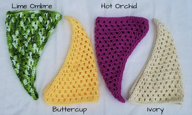 May include: Four crocheted triangle scarves in different colors: lime ombre, buttercup yellow, hot orchid, and ivory.