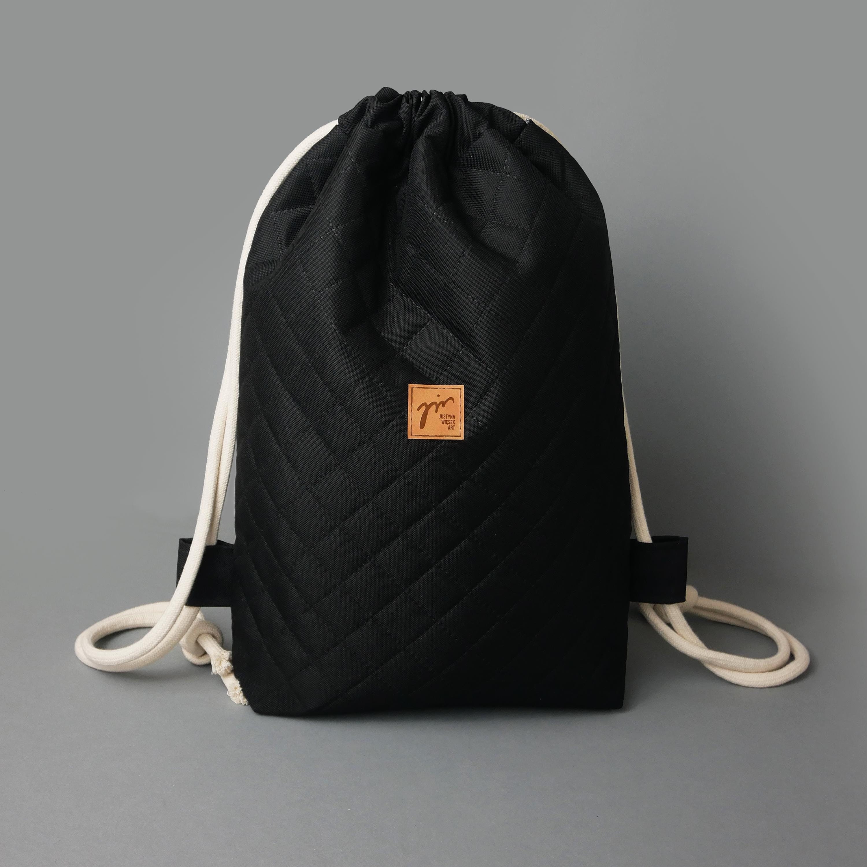 Quilted Drawstring Backpack: Elegant Black Polyester 