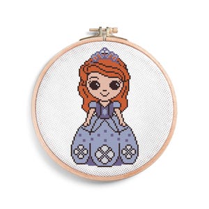 May include: A cross-stitch embroidery project in a round wooden hoop featuring a pixelated character with long wavy auburn hair, a purple tiara, and a light purple dress with a dark purple bodice and white floral-like patterns on the skirt.