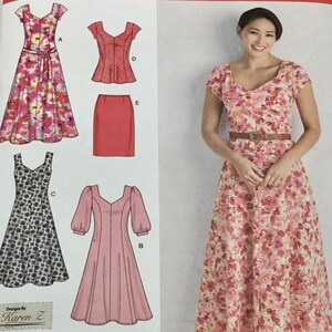 May include: Simplicity sewing pattern 2917 for sizes AA 10, 12, 14, 16, 18. The envelope displays illustrations of various dress and skirt designs, including a floral midi dress, a black and white patterned dress, a peplum top, and a skirt.