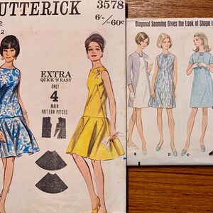 May include: Two vintage Butterick sewing pattern envelopes. One shows a blue and white floral dress, the other a yellow dress. The second envelope shows illustrations of several dresses. Text includes "Extra Quick 'N Easy" and "Diagonal Seaming Gives the Look of Shape to an Easy Fitting Dress."