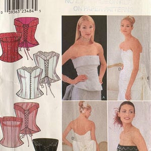 May include: Style sewing pattern 1049, size A 6-16, featuring illustrations and photographs of strapless corset-style tops with lace-up back closures, some with decorative trim, fringe, or large back bows, displayed on a white paper envelope.