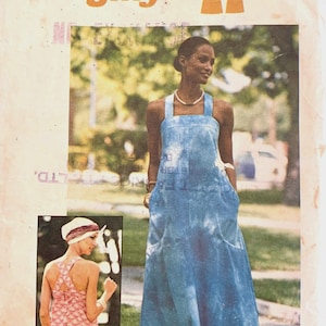 May include: A Simplicity Jiffy sewing pattern envelope 7454 for a medium size 12-14 dress. The front shows a blue sleeveless floor-length dress with wide straps and pockets, and an inset showing a pink patterned version with a cross-back design.