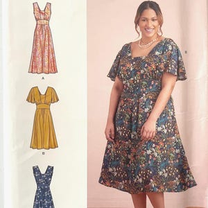 May include: Simplicity sewing pattern S9325 for a dress with a square neckline and flutter sleeves. The pattern envelope displays three variations: a sleeveless floral dress, a solid mustard yellow dress, and a blue floral dress with flutter sleeves.