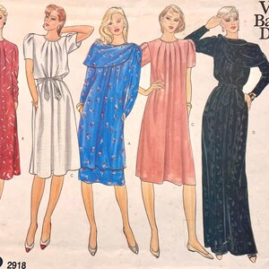 May include: A sewing pattern envelope titled Vogue's Basic Design 2918 featuring illustrations of five different dress styles. The dresses include a red patterned dress, a white belted dress, a blue floral dress, a pink dress, and a black long dress.