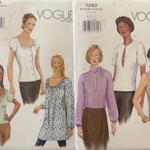 May include: Two Vogue sewing pattern envelopes, 7278 and 7282, displaying illustrations of various tops. Pattern 7278 shows three blouse styles, while 7282 features three different top designs including a lavender blouse and a sleeveless grey top.