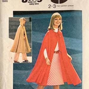 May include: Simplicity 6839 Jiffy sewing pattern envelope featuring a red cape worn over a white top and a pink and white gingham skirt, plus a smaller image of a beige hooded cape. The text includes 6839, Simplicity, Jiffy, easy cut easy sew, and 2 or 3 main pattern pieces.