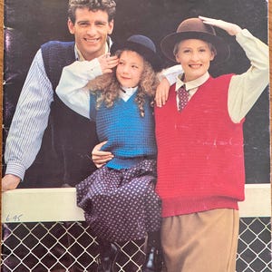 May include: A vintage knitting pattern book cover with the title "Patons." The image shows three people wearing knitted vests. The cover also displays the price and the text "10 Family Crochet Designs in TOTEM PATONKLE BLUBELL ANPACX CLASSIQUE."