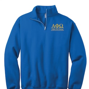 May include: A royal blue 1/4 zip sweatshirt with the Greek letters "ΑΦΩ" embroidered in gold on the chest. The letters are followed by the words "Alpha Phi Omega" in smaller gold lettering.