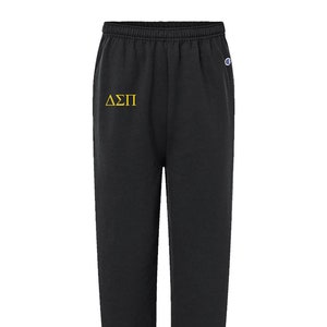Calça de moletom da marca Champion com letras gregas bordadas