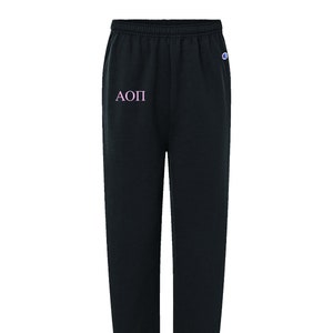 Pantalones deportivos de marca Champion con letras griegas bordadas