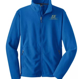 May include: A royal blue fleece jacket with a full zipper closure and two side pockets. The jacket features a high collar and the Greek letters "ΔΥ" with "Delta Upsilon" printed in gold on the chest.