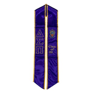 May include: Purple graduation stole with gold trim and the letters Delta Sigma Pi embroidered in gold. The stole also has a crest and the text "Class of 20" embroidered in gold.