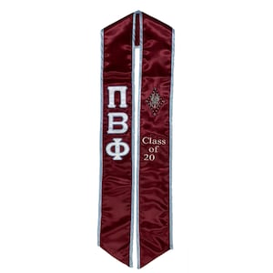 May include: Burgundy graduation stole with white lettering that reads "ΠΒΦ Class of 20".