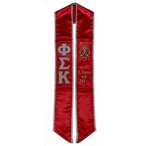 May include: Red graduation sash with silver lettering and a fraternity crest. The sash says "Phi Sigma Kappa" and "Class of 20".