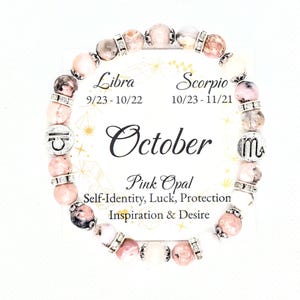 May include: Pink opal gemstone bracelet with silver charms representing the Libra and Scorpio zodiac signs. The bracelet is on a card with the text "October", "Libra 9/23-10/22", "Scorpio 10/23-11/21", "Pink Opal", "Self-Identity, Luck, Protection", and "Inspiration & Desire".