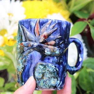 Small hand made bird of paradise mug with drippy blue textured glaze and hand sculpted flowers, bird of paradise mug, flower mug, strelitzia