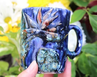 Small hand made bird of paradise mug with drippy blue textured glaze and hand sculpted flowers, bird of paradise mug, flower mug, strelitzia